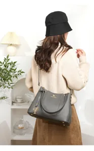 Detail view of the elegant lychee pattern women shoulder bag with chic metal pendant and hardware.