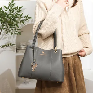 Chic grey tote handbag for women with litchi grain and stylish pendant, versatile daily bag.