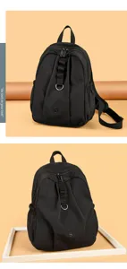 Sac à dos noir imperméable avec design plissé, anneau métallique avant et fermeture éclair quotidienne.