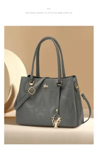 Gray embossed letter women handbag with metal charm, stylish commuter tote bag for daily use.