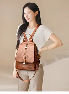 Detailed view of vintage brown leather backpack worn by model, showcasing premium texture.