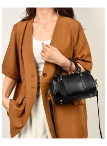 Detailed view of the stylish black leather boston bag with metal hardware and handle.