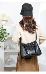 Detailed view of the black embossed leather handbag showcasing exquisite texture and elegant style.