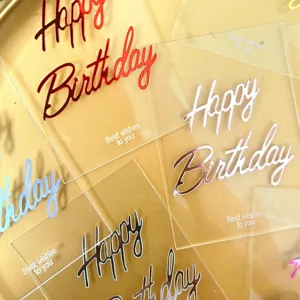 Transparent acrylic birthday cake topper detail, colorful mirror finish script lettering.