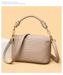 Detail view of the elegant faux leather crocodile pattern shoulder handbag with gold hardware.