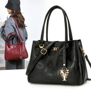Stylish women leather handbag with embossed letters, top handle tote and chic metal charm.