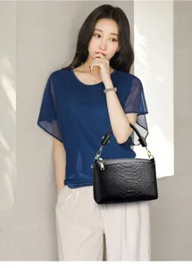Elegant black crocodile texture handbag for women, stylish shoulder and tote bag with gold hardware.