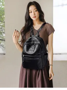 Women's black retro oil wax leather backpack with metal zippers and stylish casual design.