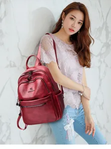 Vintage oil wax leather backpack for women, multi-pocket travel school bag with stylish design.