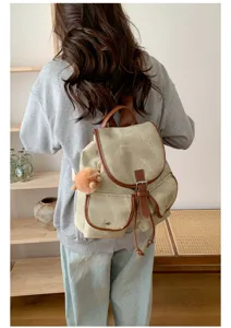 Korean style casual canvas women backpack with brown leather trim and dual pockets.