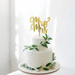 Gold acrylic Mr & Mrs wedding cake topper detail view, elegant party decoration accessory.