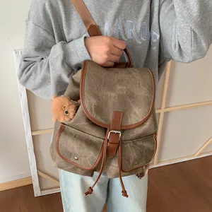 Casual Korean style canvas backpack for women with dual pockets and drawstring design.