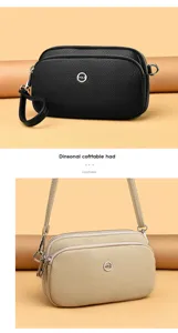 Detailed view of the multi-layer leather crossbody bag with stylish metal logo and strap.