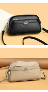 Double layer leather crossbody bag with front zipper pocket and stylish metal heart logo detail.
