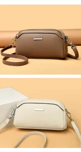 Small leather texture crossbody phone bag with double zippers and silver metal bar detail
