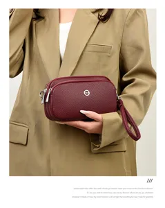 Wine red multi-layer leather clutch bag for women, stylish phone purse with wrist strap detail.
