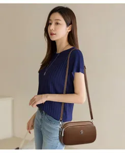 Brown leather crossbody bag with multiple compartments, stylish small shoulder bag for women.