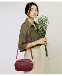 Stylish women's leather cross-body shoulder bag with multi-layer zipper and elegant design.