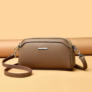 Elegant brown leather crossbody shoulder bag with double compartments and stylish silver hardware.