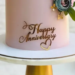 Gold acrylic Happy Anniversary cake topper detail, elegant dessert table decor ornament.