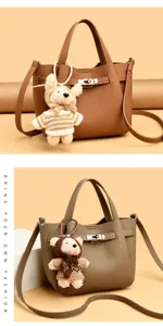 Stylish leather handbag with lock closure and cute bear pendant, perfect for daily casual wear.