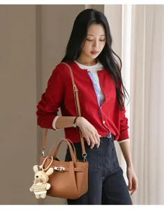 Stylish leather lock handbag bucket bag for women, chic crossbody shoulder bag with cute knit pendant.