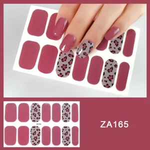 Detailed view of trendy leopard print and solid pink nail stickers, smooth finish texture.