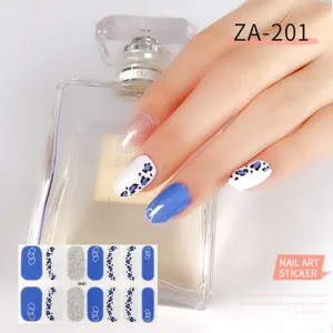 Close-up detail of blue leopard print and glitter nail art stickers on hand model, stylish.