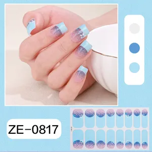 Detailed view of French gradient blue glitter nail wraps with small floral art and swatches.
