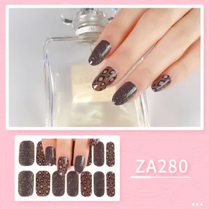 Stylish brown leopard print nail wraps with glitter gradient for trendy and chic manicures.