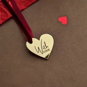 Gold mirror heart cake topper with red velvet ribbon, perfect for Valentine's Day party decor.