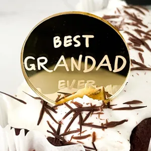 Close-up detail of gold acrylic cake topper with best grandad ever text for fathers day.
