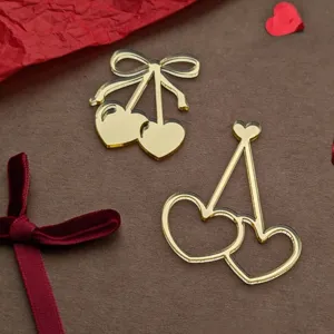 Gold acrylic heart cherry cake topper, sweet bow design for Valentine's Day baking decor detail.