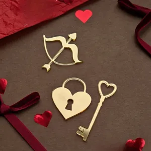 Detailed view of gold acrylic cake toppers, heart lock and key design for Valentine's day.