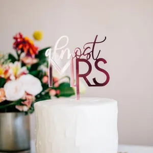 Rose gold acrylic cake topper featuring elegant almost mrs script font for bridal shower party.