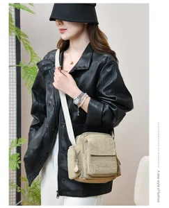 Detailed view of multi-pocket waterproof canvas crossbody shoulder bag with adjustable strap.