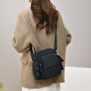 Multi-pocket waterproof crossbody camera bag, casual shoulder bag for outdoor daily use.