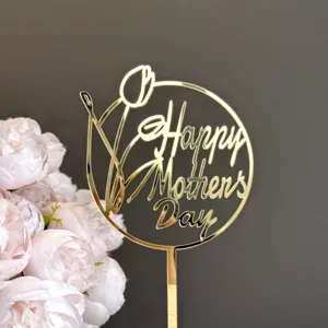 Gold acrylic Mother's Day cake topper detail featuring tulip and lettering design for party decor.