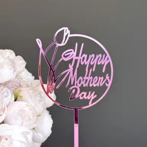 Close-up detail shot of pink acrylic Happy Mother's Day cake topper with tulip design.