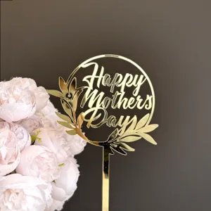 Gold acrylic Mother's Day cake topper close-up view featuring a elegant circular leaf design.