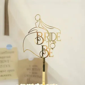 Gold acrylic bride to be cake topper for wedding and bachelorette party decoration.