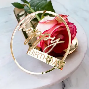 Gold acrylic happy birthday cake topper, elegant party decoration for celebration.