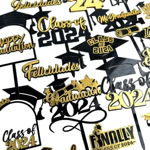Detailed shot of black and gold acrylic graduation cake toppers with 2024 class text.