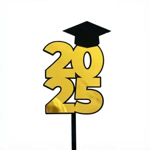 Close-up detail view of the black and gold 2025 graduation cake topper with a graduation cap.
