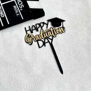 Black and gold acrylic graduation cake topper detail, elegant graduation party decoration prop.