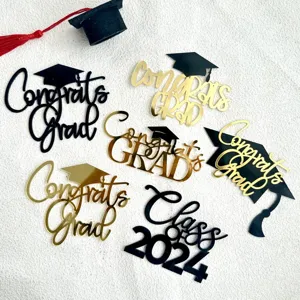 Acrylic graduation cake topper set featuring black and gold Congrats Grad and Class of 2024 designs for party.