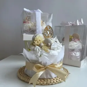 Easter decorative cake detail featuring acrylic topper, meringue and gift box packaging setup.
