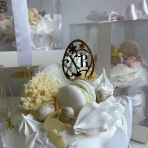 Easter acrylic cake topper detail showing the golden egg design with decorative elements and bakery.