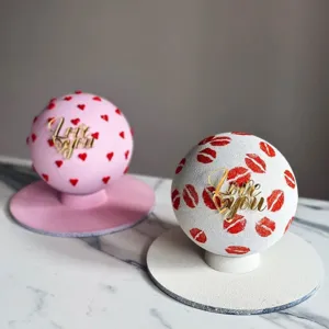Valentine velvet spherical cake with gold acrylic Love You topper and romantic heart lips decor.