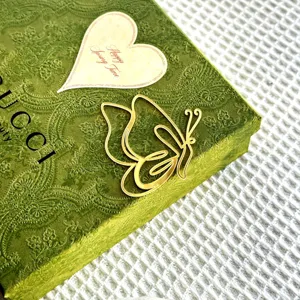 Gold acrylic butterfly cake topper for Mother's Day party celebration and baking decor.